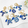 Blue Resin Alphabet Letter Keychain With Butterfly Evil Eye Charm Tassel view 1