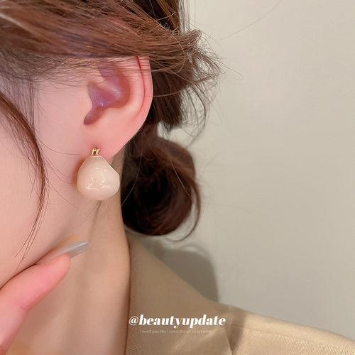 Detail view 2 of glossy rounded hoop earrings in neutral colors statement jewelry