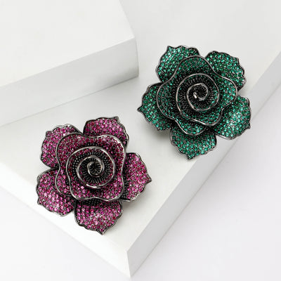 Product display showing a layered rose densely set with colored pavé crystals