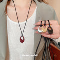 Open Oval Cord Pendant Necklace in Red and Silver Tones view 1