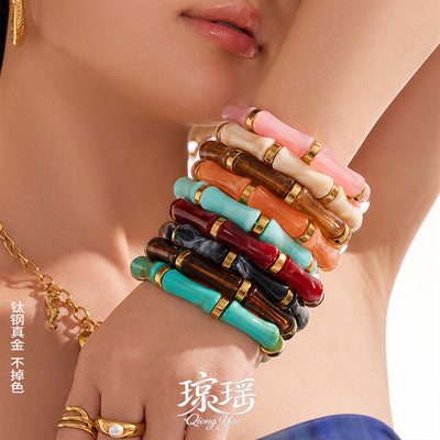 On-wrist view of bamboo shape resin stretch bracelets in main image 1.