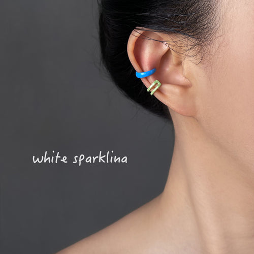 Blue and green clip-on ear cuffs worn on upper and mid ear