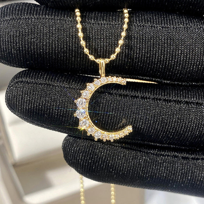 Gold Tone Crescent Moon Pendant Necklace with Clear Stones