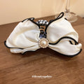 White Satin Bow Hair Claw With Black Piping And Pearl Like Center view 2