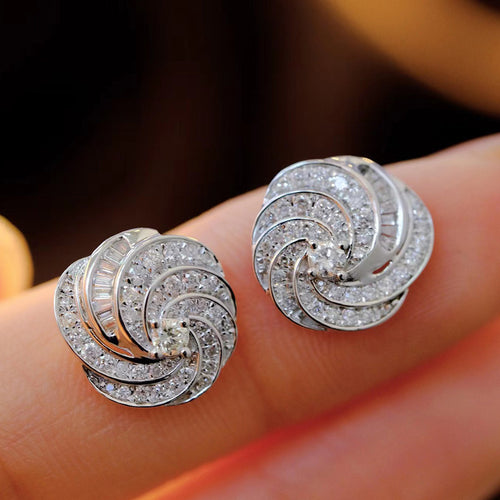 Second product view showing pave swirl round cluster stud earrings in polished silver tone