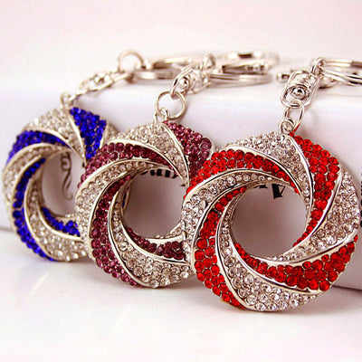 Three open circle rhinestone keychains shown in blue, purple, and red.
