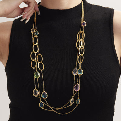 Neckline view of teardrop glass stone long necklaces in main image 1.
