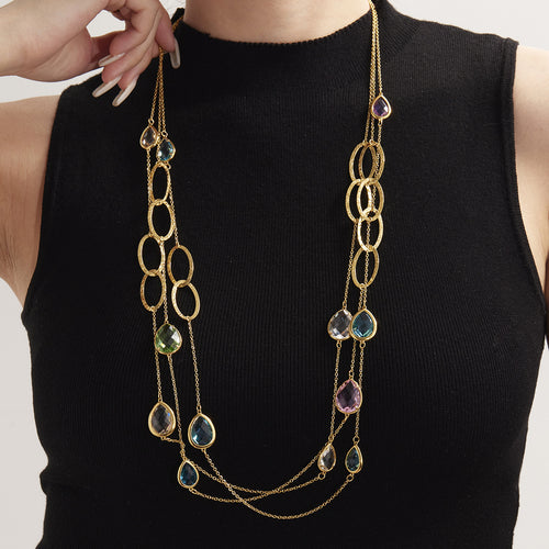 Neckline view of teardrop glass stone long necklaces in main image 1.