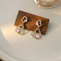 Gold Double Heart Pink Accent Long Dangle Stud Earrings view 2
