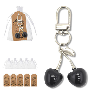 Black cherry keychain beside an organza bag set, five bags, and five thank-you tags.