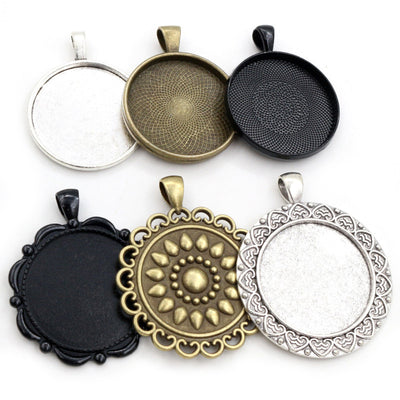 Round Pendant Bezel Trays in Twenty Five Frame Styles assortment on a plain background