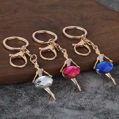 Three ballet dancer keychains with faceted colored skirts