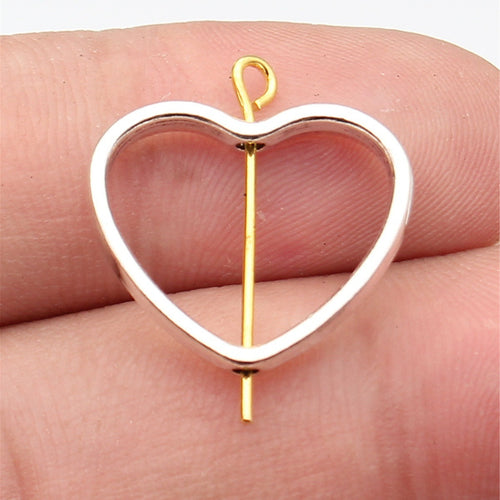 open heart frame beads shown on fingertips for scale