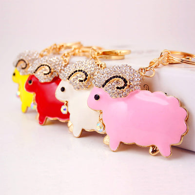 Yellow, red, white, and pink ram keychains are arranged in a row.