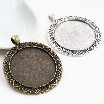 Finish comparison of round recessed trays surrounded by a repeating pointed leaf border in two antique finishes