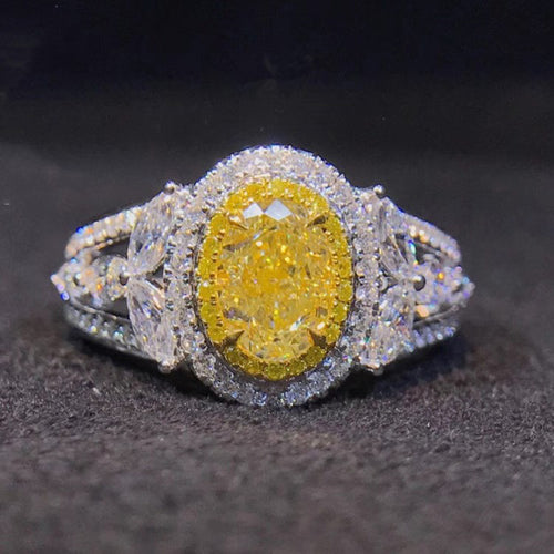 Yellow oval halo ring front face on dark textured surface