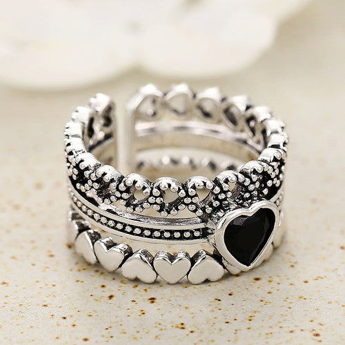 Back view silver openwork multi band ring with black heart stone
