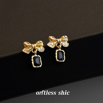 Gold Tone Textured Bow And Black Rectangular Stone Drop Earrings