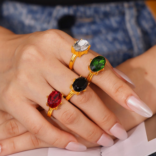 Styled hand view of oval faceted glass statement rings in main image 1.