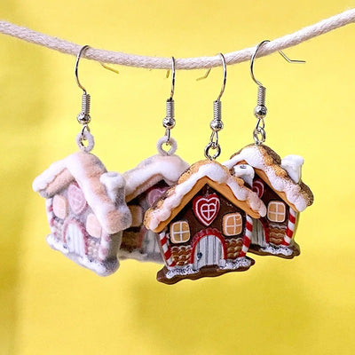 Flocked and smooth resin snow house earrings hanging on rope yellow background