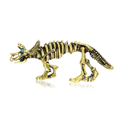 Antique gold triceratops skeleton brooch green eye stone on white background
