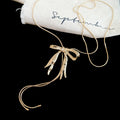 Bow and Ribbon Tassel Necklaces in Gold and Silver Tones view 6
