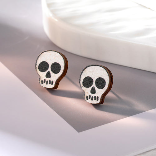 Close-up showing the colors and surface details of halloween Wood Skull Ghost and Spider Stud Earrings in Nineteen Desig