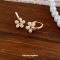Gold Tone Flower Huggie Earrings with Crystal Petals view 4