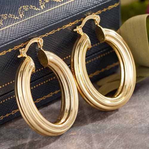 Alternate close view of the gold tone earrings