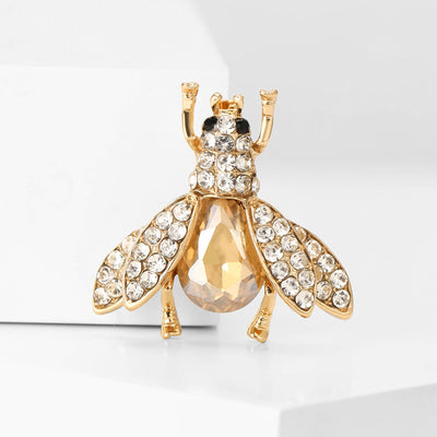 Champagne crystal bee brooch on white block