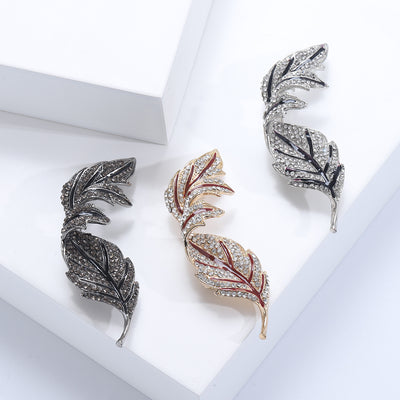 Curved Crystal Leaf Brooch in Three Tones displayed from the front