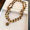 Tiger Eye Look Beaded Round Pendant Necklace With Decorative Metal Details view 1