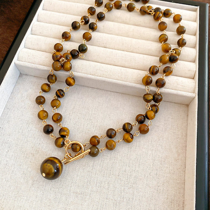 Tiger Eye Look Beaded Round Pendant Necklace With Decorative Metal Details