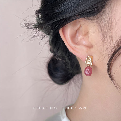 Pink red stone gold leaf drop studs on woven fabric tray