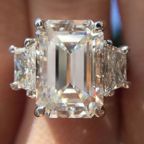 Product view showing silver-tone oversized rectangular solitaire three-stone ring
