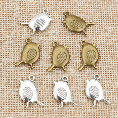 small side-profile bird charm assortment on a light background