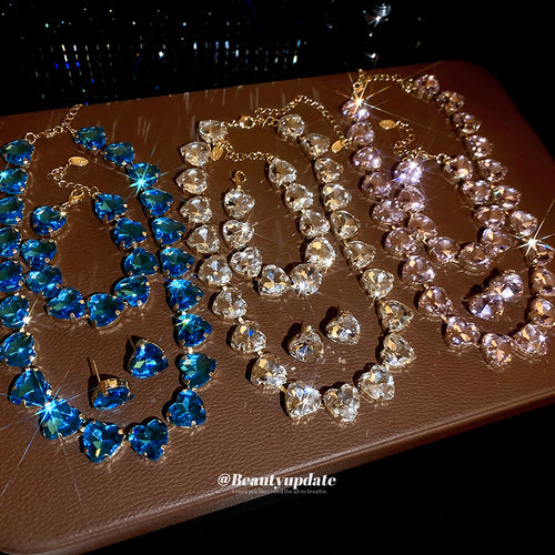 Blue clear and pink gold heart crystal multi-piece sets on brown tray