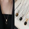 Oval Black Cabochon Pendant Necklace in Gold and Silver Tones view 1