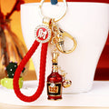 Jeweled Wine Bottle Keychains in Three Red and Braided Loop Configurations view 1