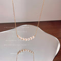 Gold Tone Chain Necklace With Graduated White Pearl Curved Centerpiece view 2
