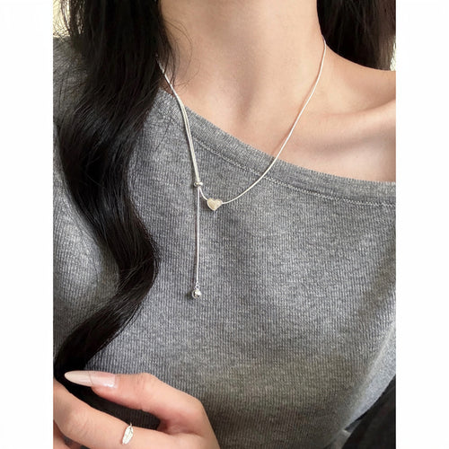 Silver Tone Sliding Heart Lariat Necklace with Bead Ends shown in a styled close-up