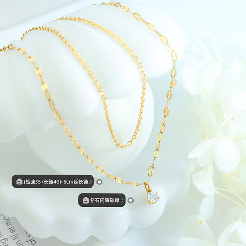 Gold layered necklace flat lay with length and zircon labels