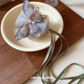 Gray Green Translucent Bow Hair Claw With Pearl Like Center And Ribbon Tails view 4