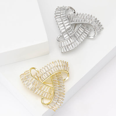 Three interlocking curved geometric loops set with crystals shown on a white background.