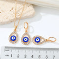 Gold Tone Crystal Teardrop Evil Eye Necklace and Huggie Earrings view 5
