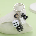 Dice Charm Keychains Featuring Black Moon Across 10 Pictured Variations view 1