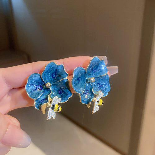 Front view of blue floral statement earrings