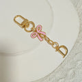 Gold Tone Initial Letter Keychain With Pink Enamel Bow Charm view 9