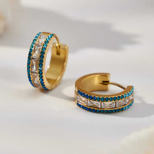 On-ear view of triple row crystal hoop earrings in main image 1.
