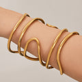 Sculptural Crossing Loop Open Cuff in Gold and Silver Tone view 1